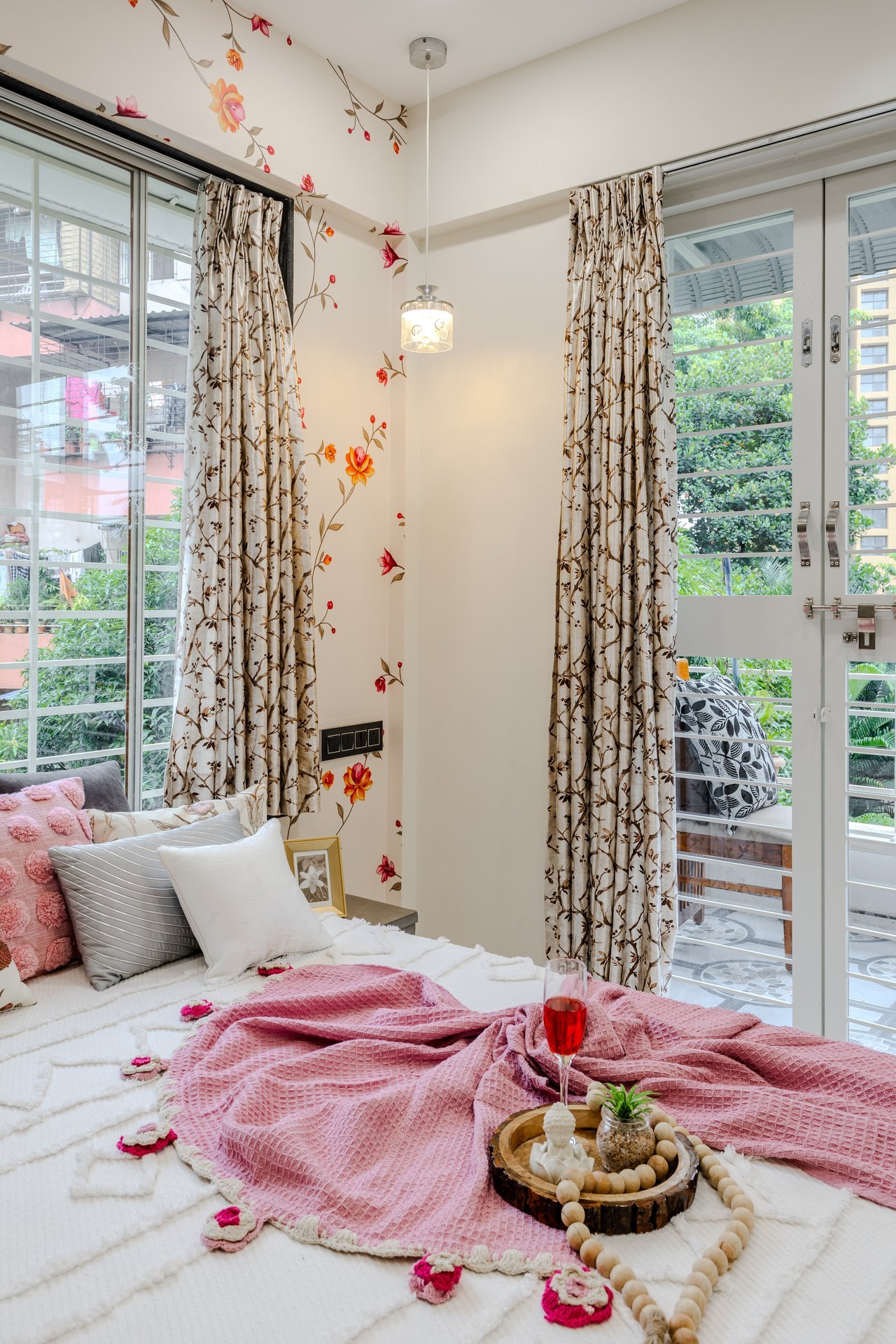 Master bedroom bed styling with balcony view by Design DNA