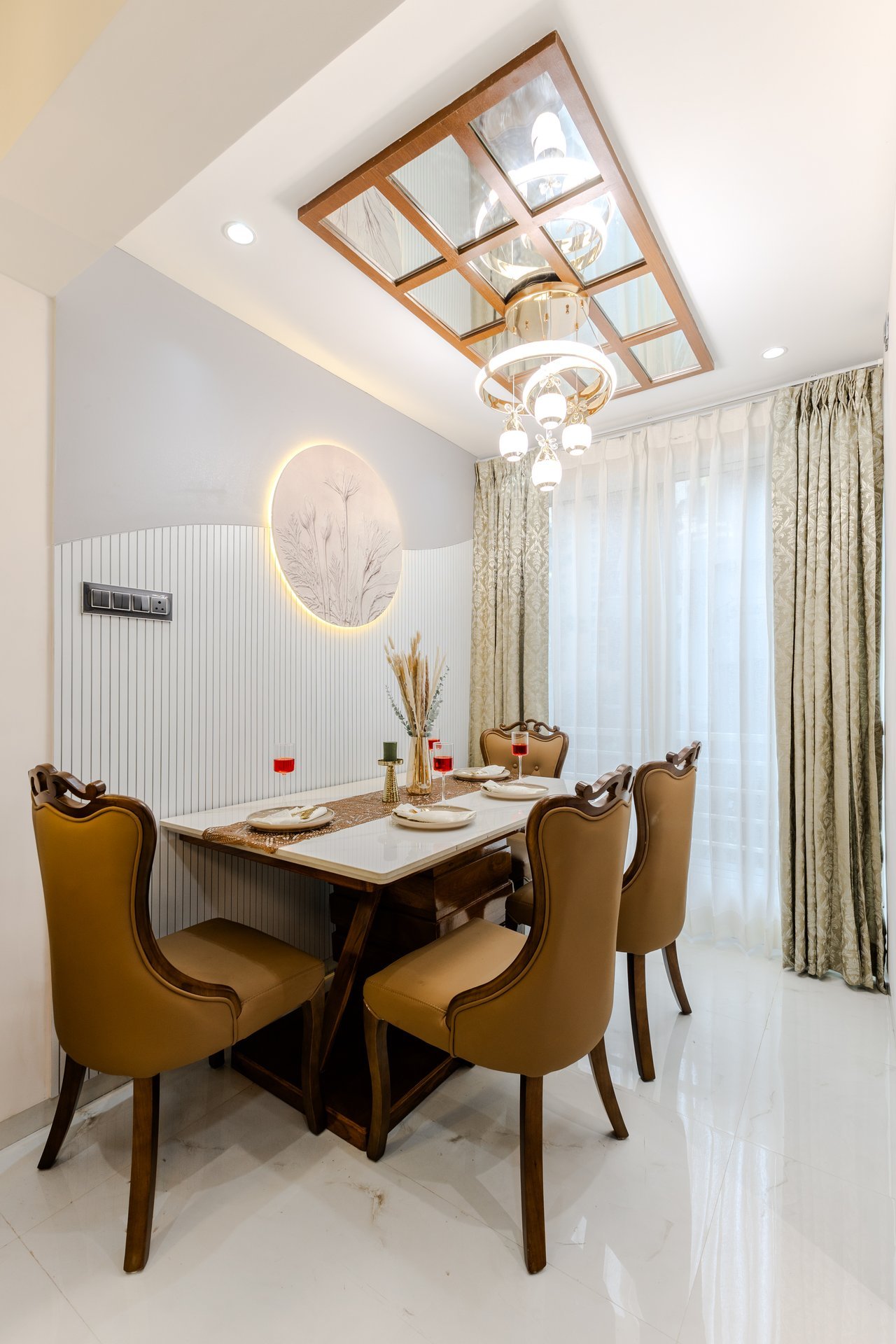 Contemporary dining room with mirrored ceiling and chandelier by Design DNA